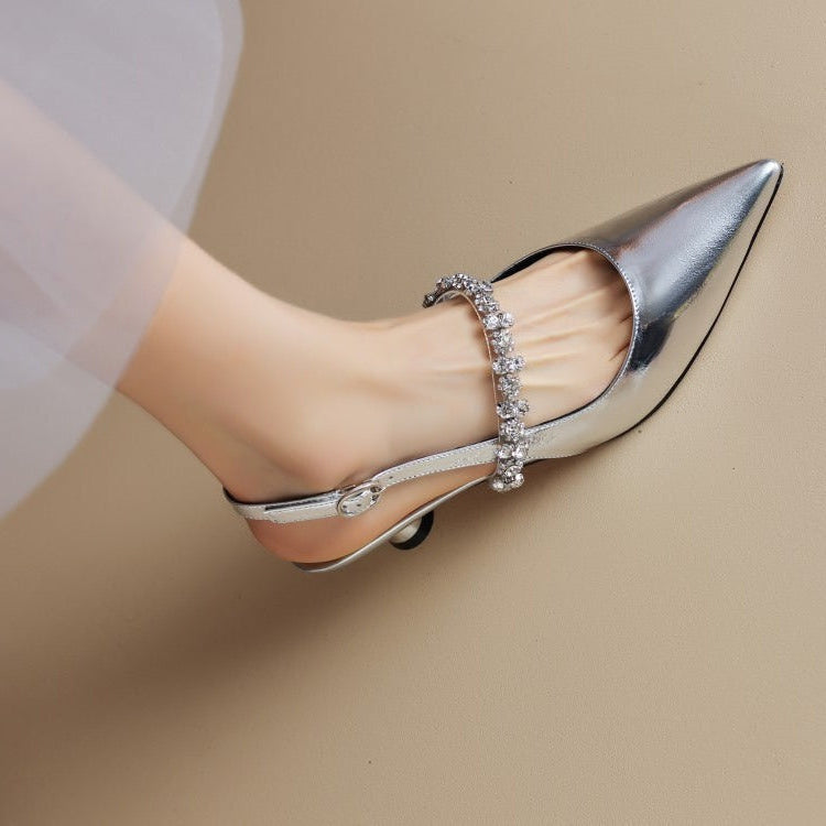 Silver pointed-toe pumps with rhinestone cross-strap and low heel