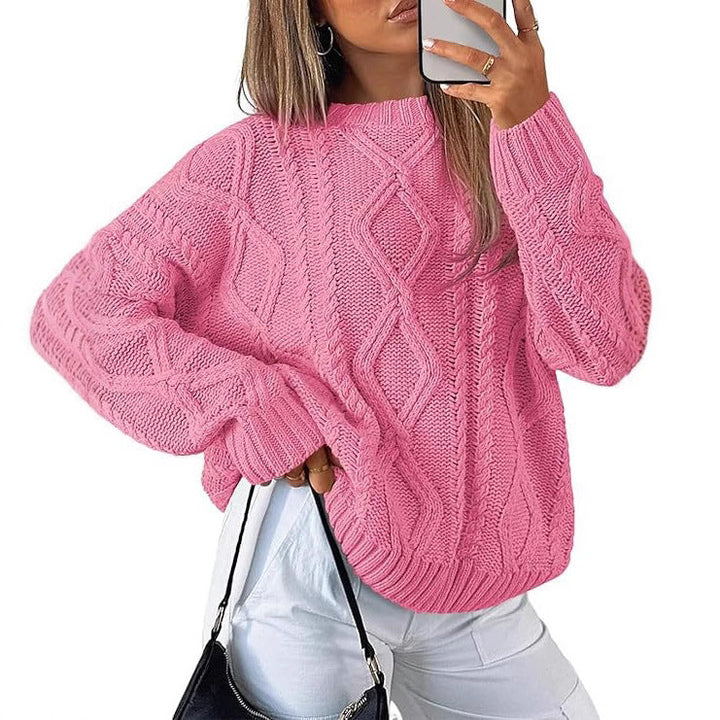 Pink oversized cable-knit sweater with long sleeves and crew neck
