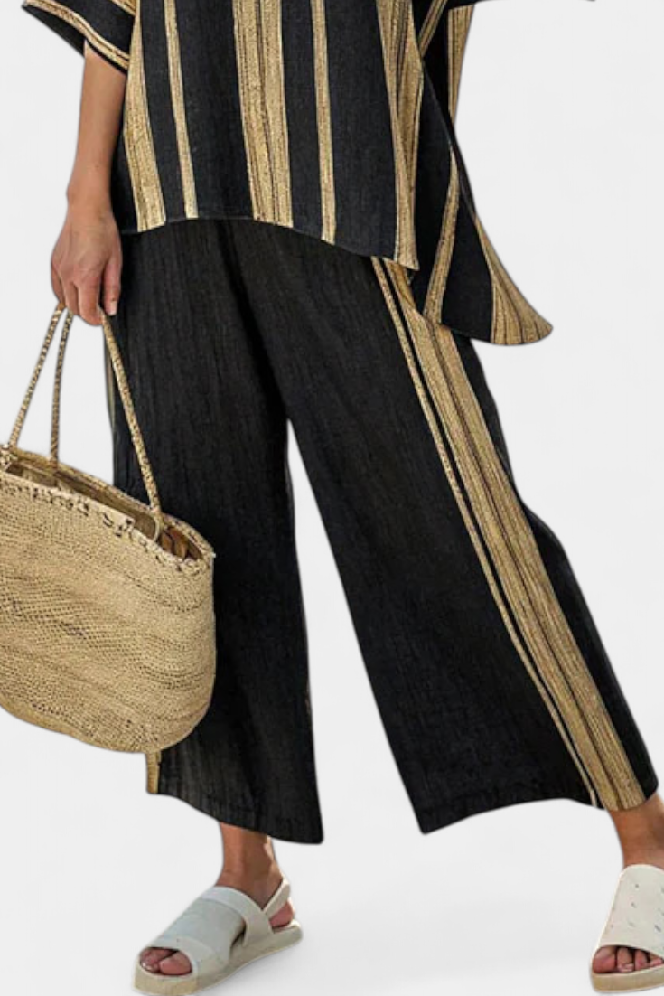 Black linen trousers with gold stripe trim, worn with striped oversized top