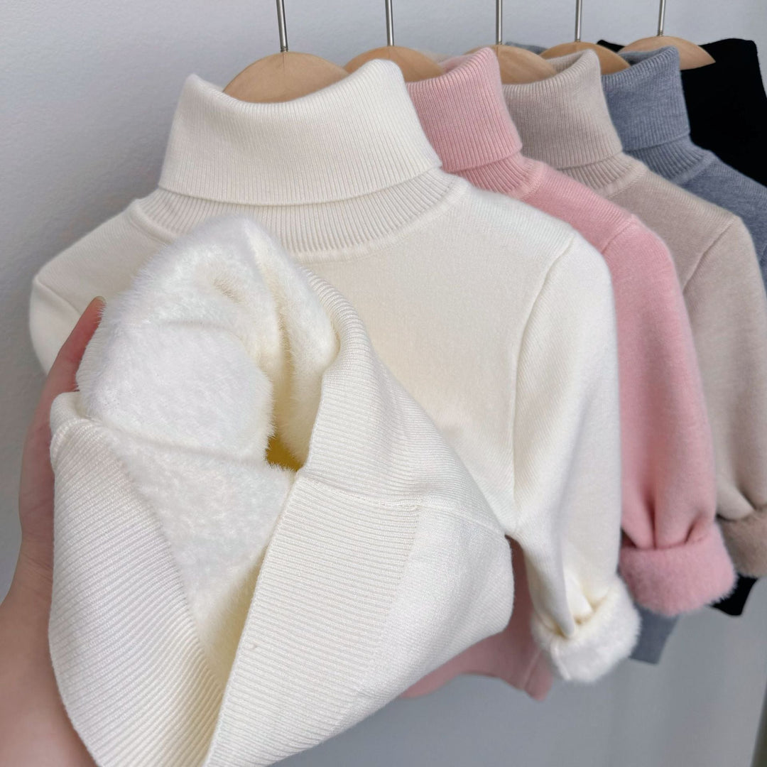 White fleece-lined knit sweater with ribbed turtleneck; plush lining peeks from sleeve