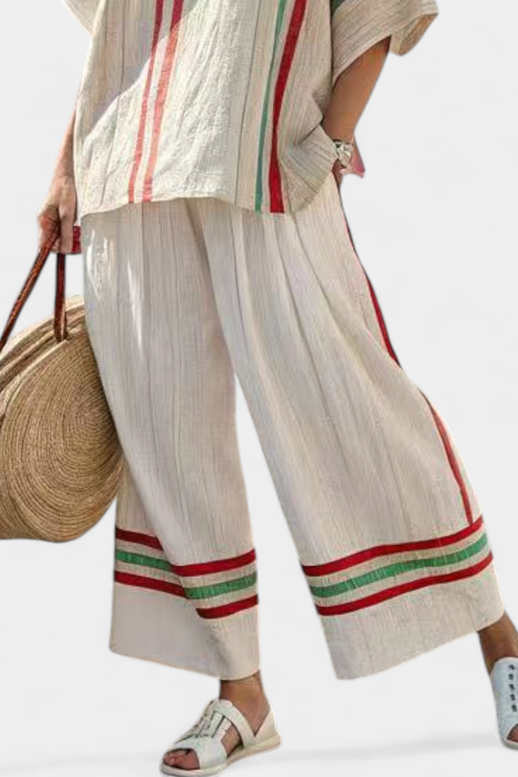 Wide-leg pants with striped hem and vertical panel detail, cream with red and green bands