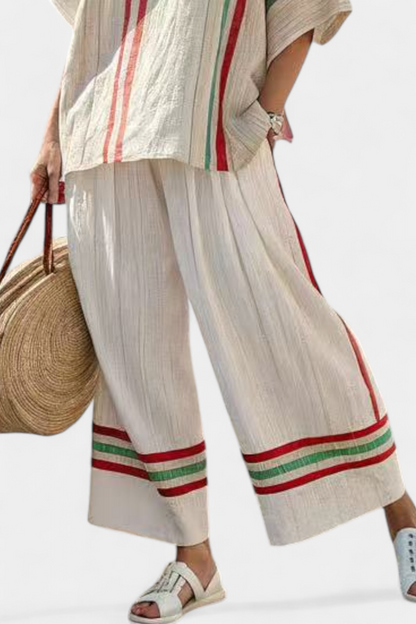 Wide-leg pants with striped hem and vertical panel detail, cream with red and green bands