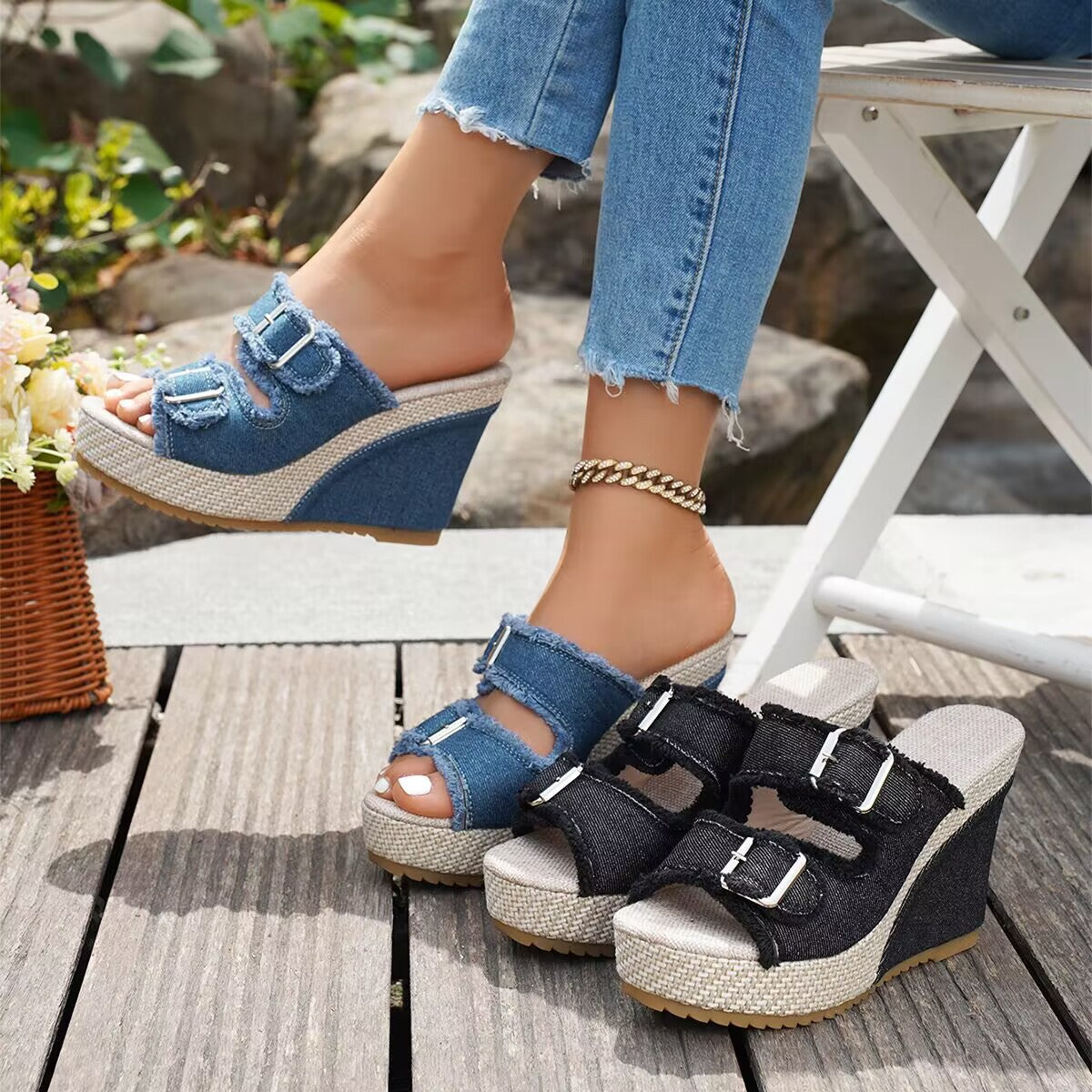 Black wedge sandals with three buckle straps and open toe, platform sole