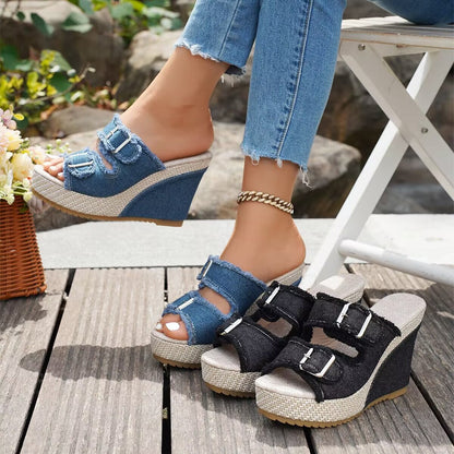 Black wedge sandals with three buckle straps and open toe, platform sole