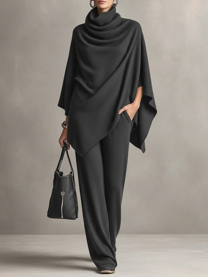 Black cowl-neck draped top and wide-leg trousers set, poncho-style hem