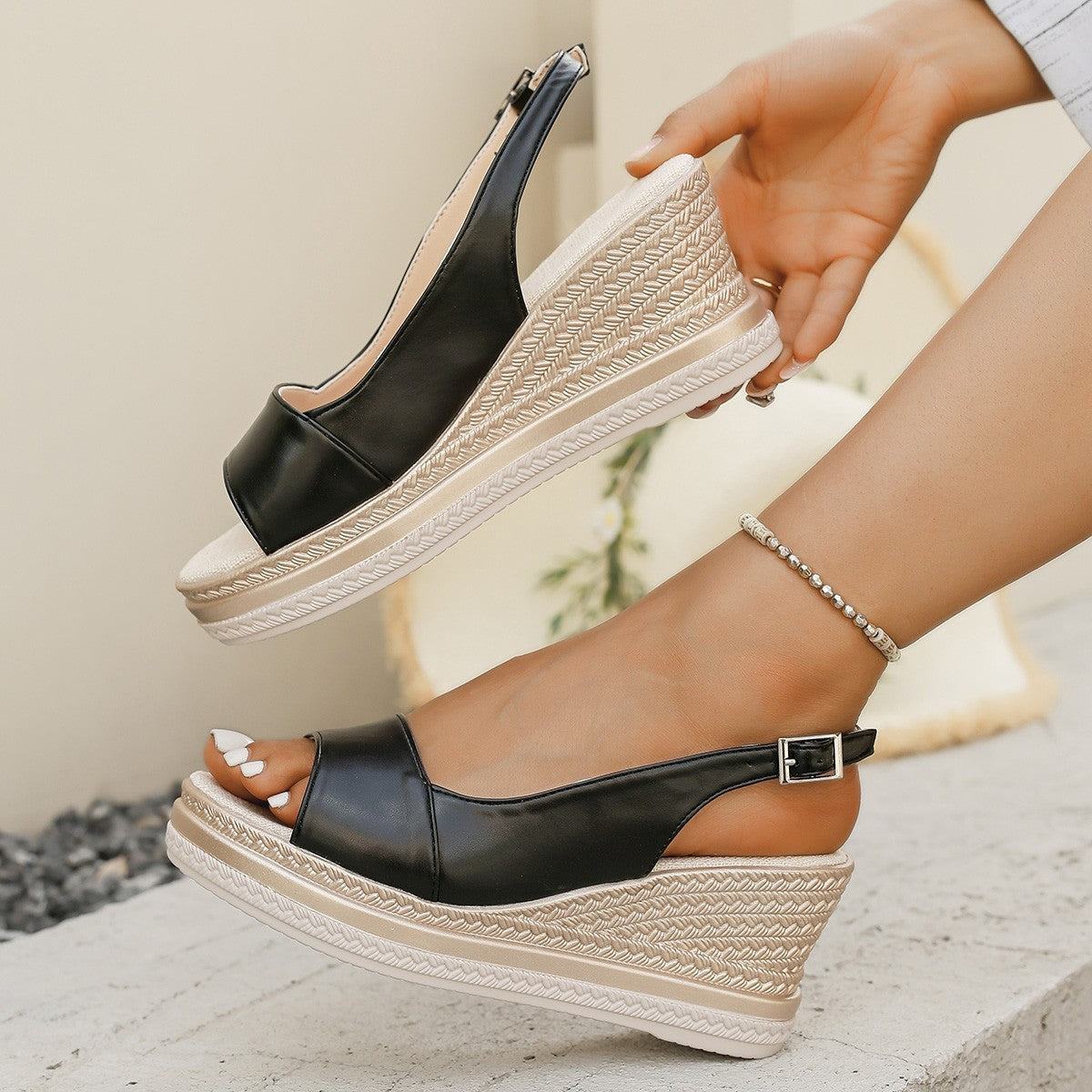 Black orthopaedic wedge sandal with buckled ankle strap and textured platform sole