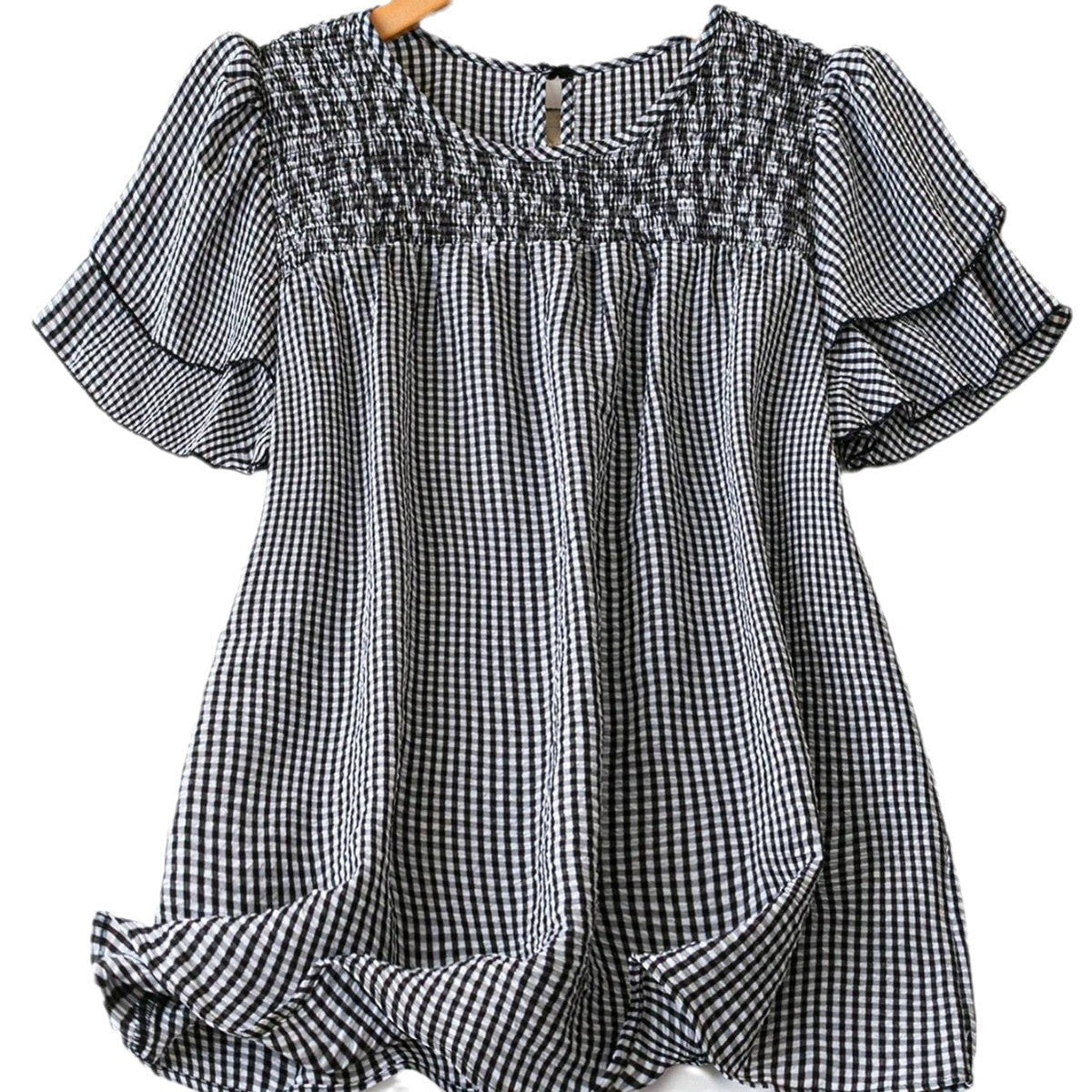 Black-and-white checkered puff-sleeve blouse with smocked yoke and keyhole button neck