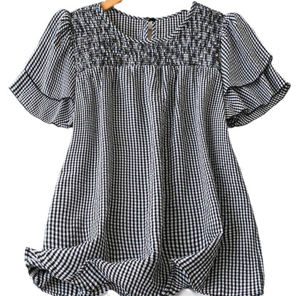 Black-and-white checkered puff-sleeve blouse with smocked yoke and keyhole button neck