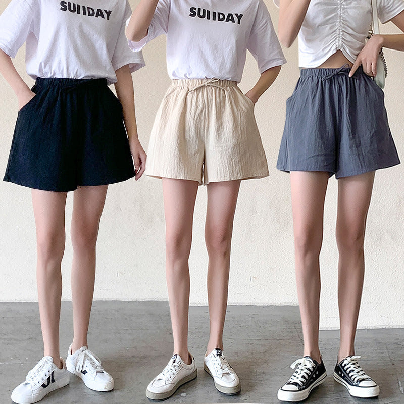 Relaxed-fit shorts on models: black, cream, and navy; elastic waistband with drawstring