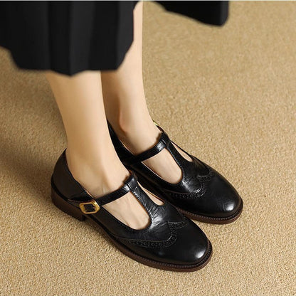 Black Mary Jane shoes with buckle strap and brogue-style stitching