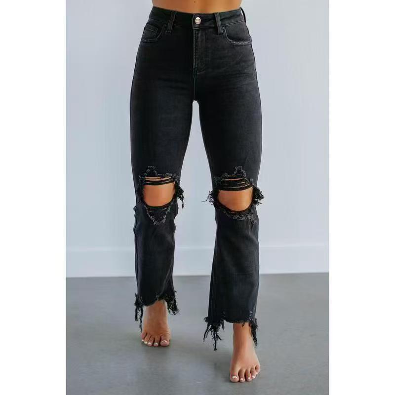 Black washed slim-fit ripped jeans with large knee rips and frayed ankle hems