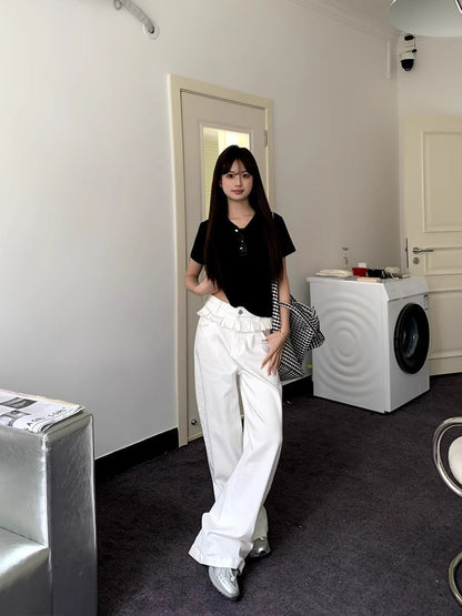 White wide-leg jeans with pleated front and lace-trim ruffled waistband