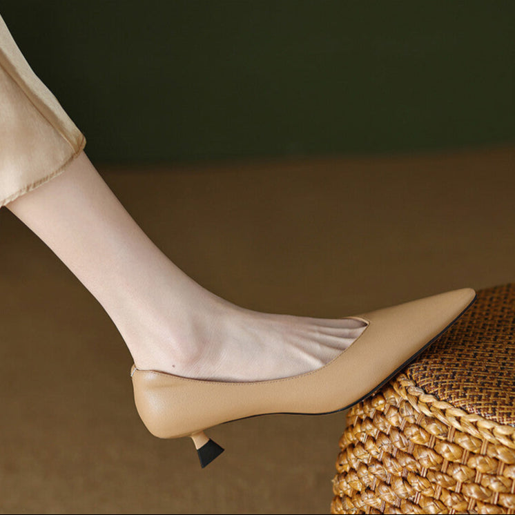 Beige pointed-toe pumps with low block heel, side view