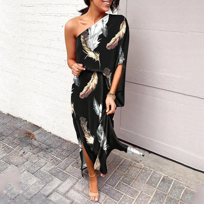 One-shoulder floral maxi dress in black with beige and white feather-like botanical print