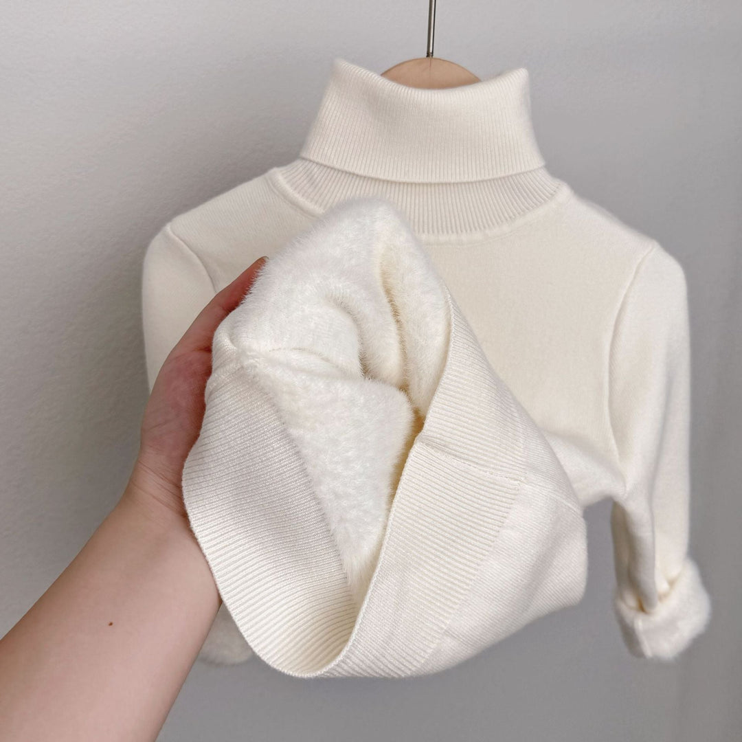 White fleece-lined knit sweater with ribbed turtleneck; plush lining shown on sleeve