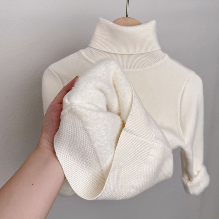 White fleece-lined knit sweater with ribbed turtleneck; plush lining shown on sleeve