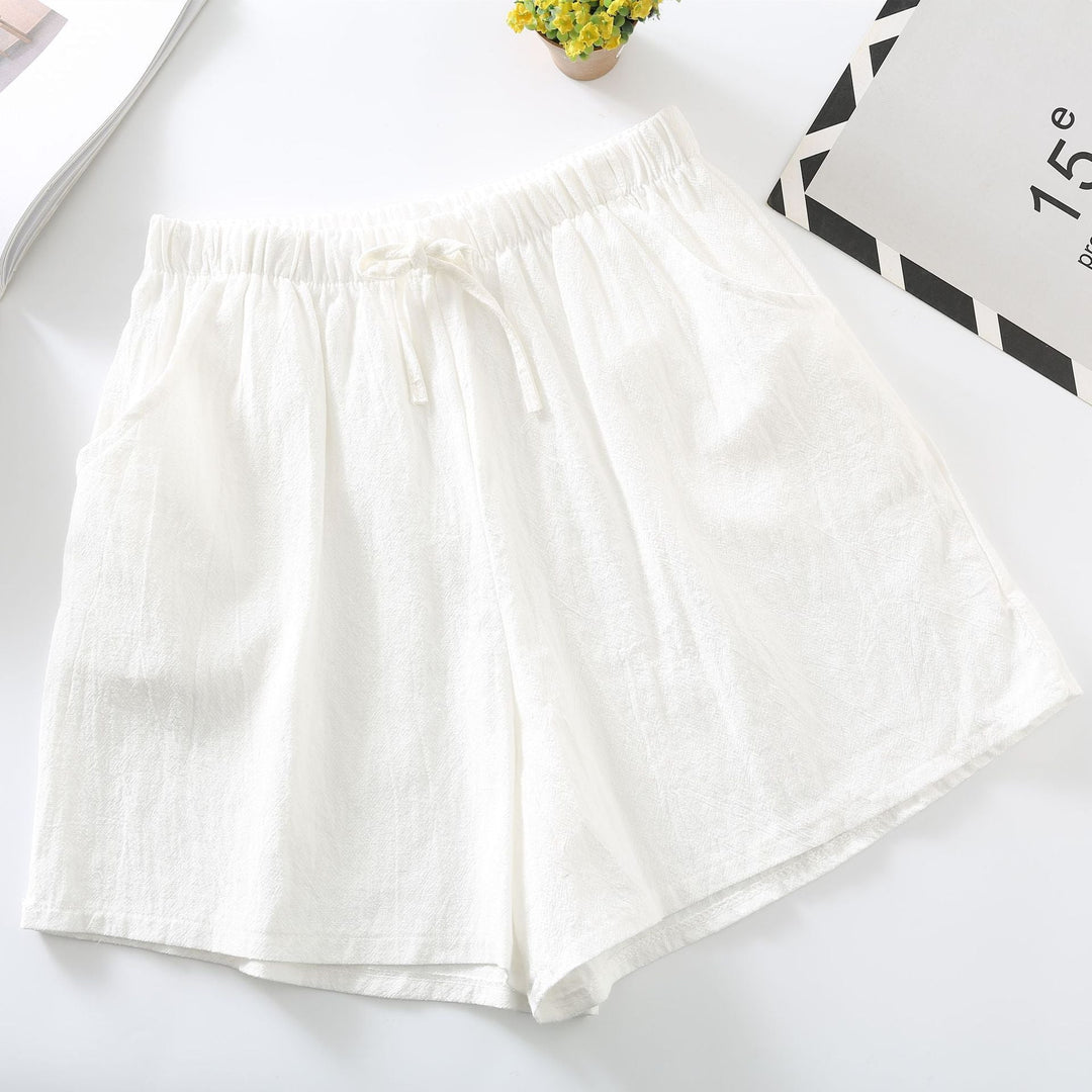 White relaxed-fit shorts with elastic waistband and drawstring tie