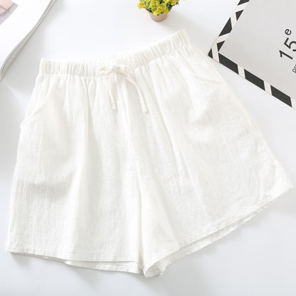 White relaxed-fit shorts with elastic waistband and drawstring tie