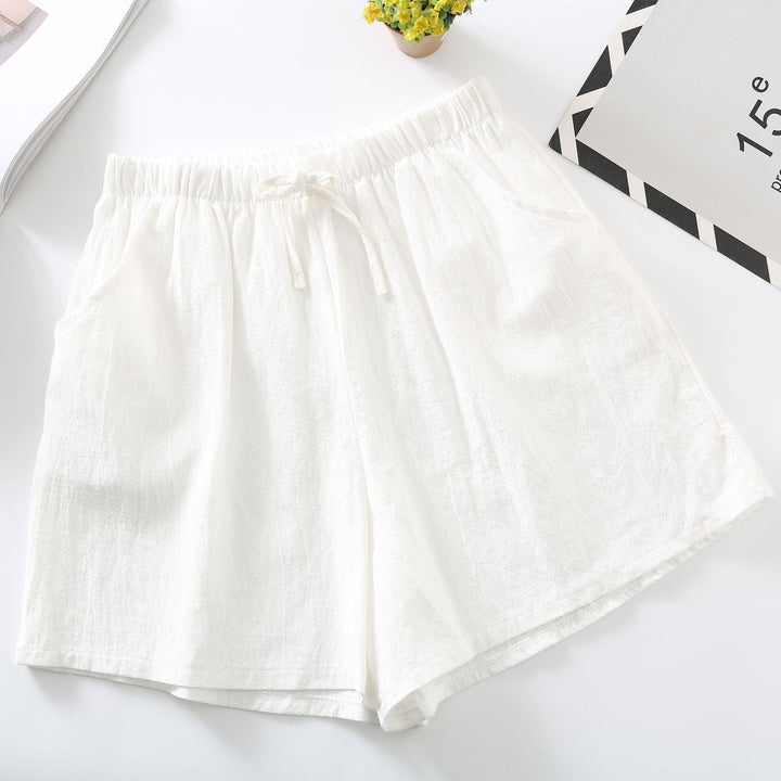 White relaxed-fit shorts with elastic waistband and drawstring tie