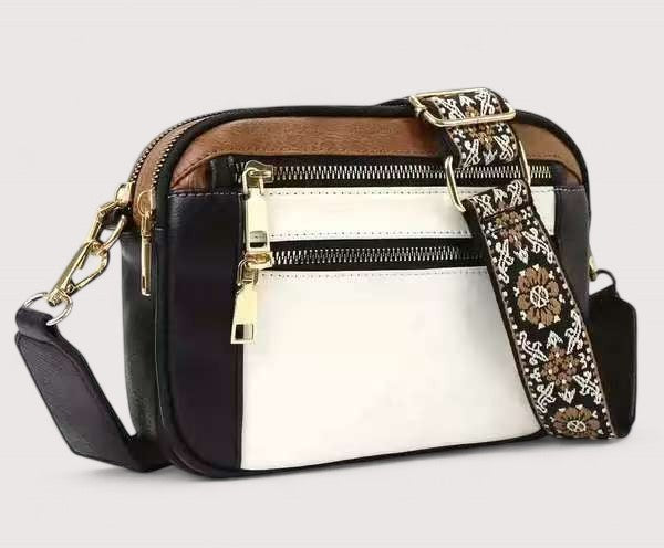 Two-tone lightweight crossbody bag with top zip, patterned strap, and white front panel.