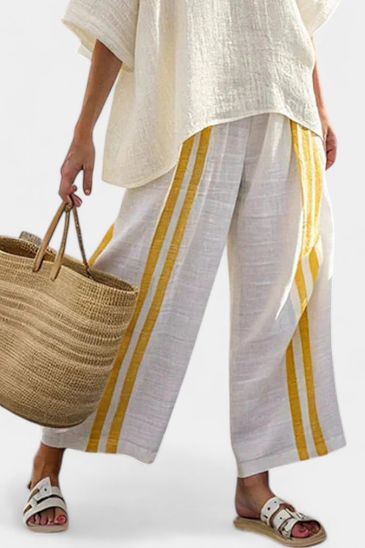 Yellow-striped wide-leg white linen trousers with off-white tunic top.