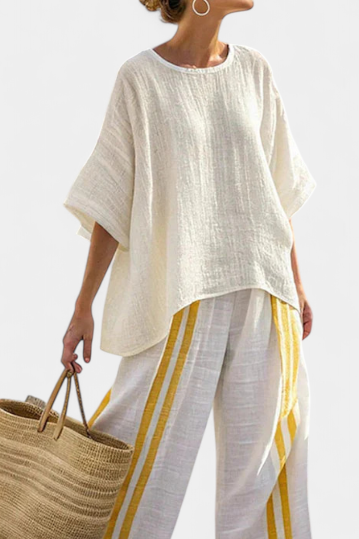 Off-white linen tunic top with short sleeves and yellow-striped wide-leg trousers.