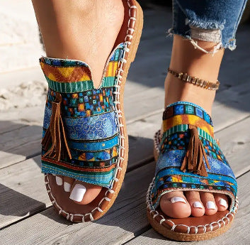 Printed slip-on sandals with toe ring, fringe tassel, and rope-stitched trim, blue pattern
