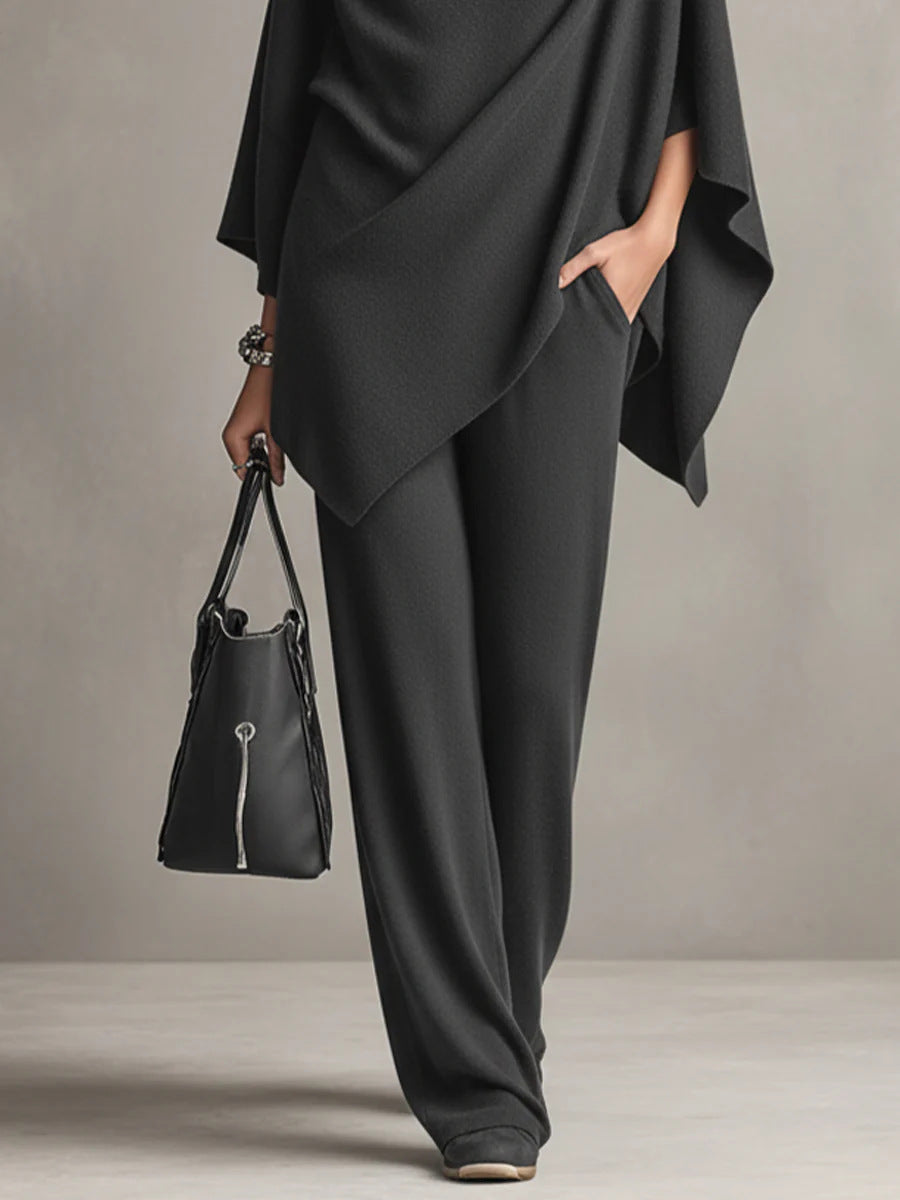 Black wide-leg trousers with draped cowl-neck cape top and flowing side panel