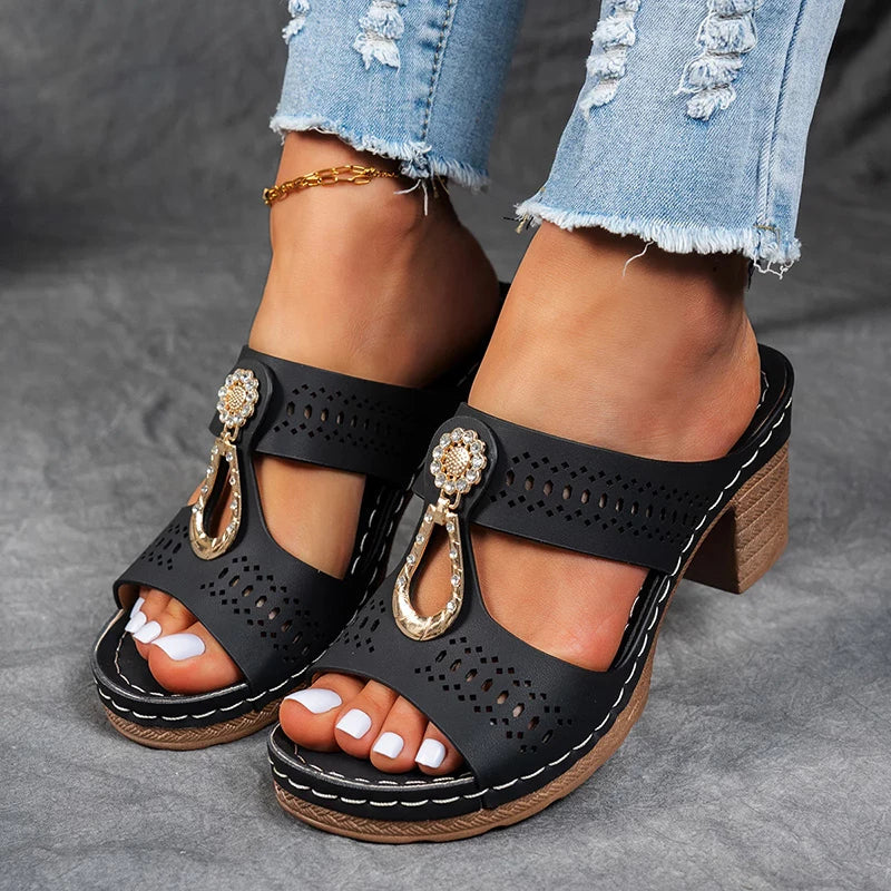 Black orthopedic sandals with perforated leather straps and jeweled T-strap