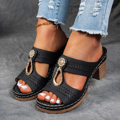 Black orthopedic sandals with perforated leather straps and jeweled T-strap