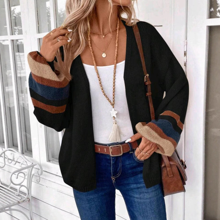 Black open-front knit cardigan with striped cuffs and lantern sleeves