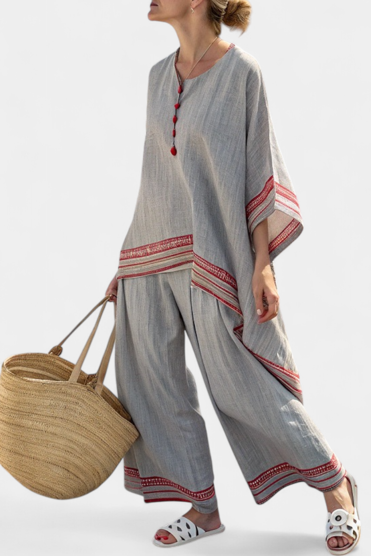 Asymmetric blouse and wide-leg trousers set in gray with red striped cuffs and tassel neckline