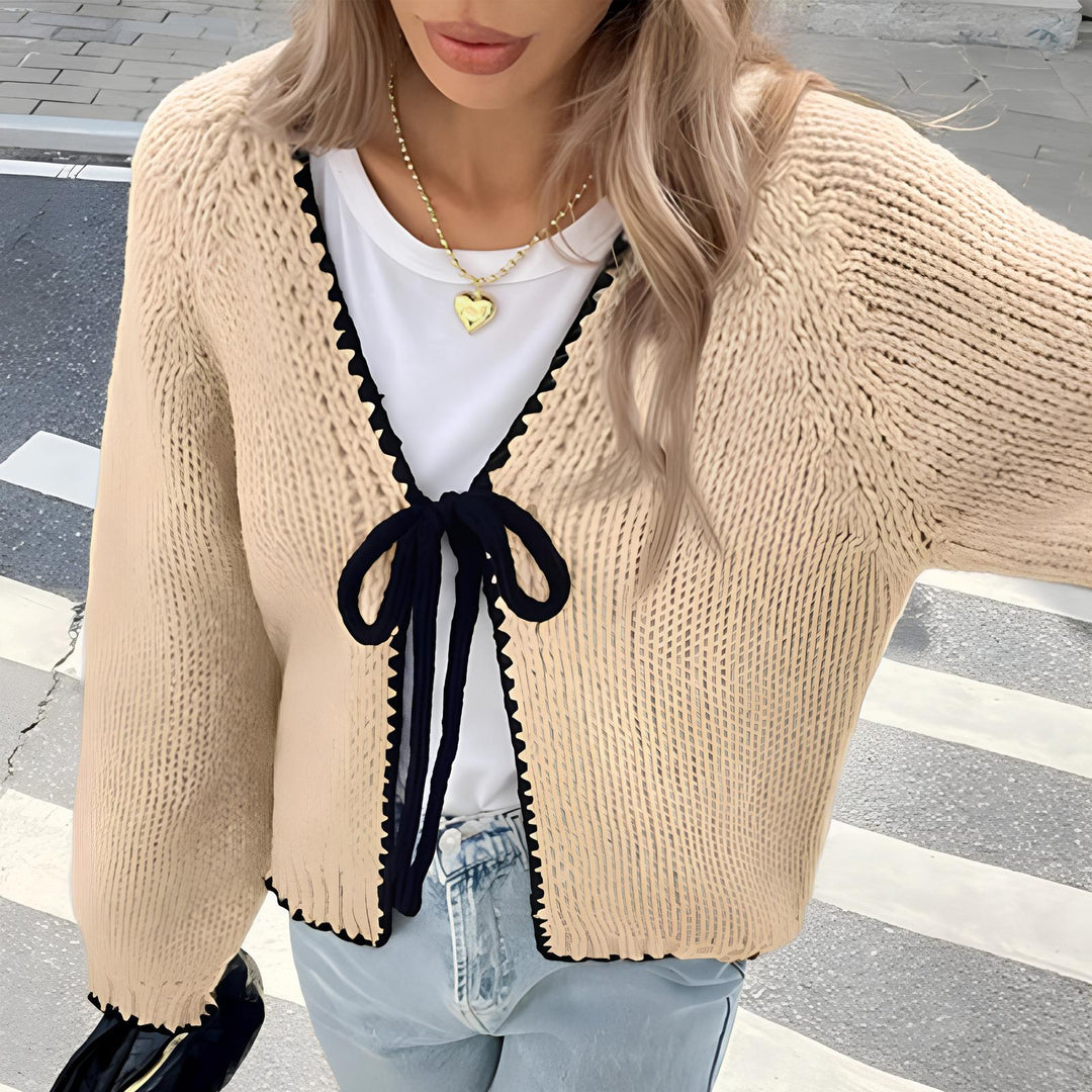 Cream open-front long sleeve cardigan with scalloped edge and navy ribbon tie