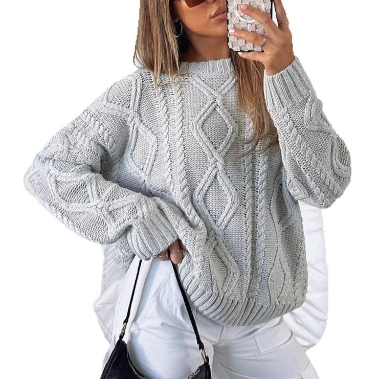 Light gray oversized cable-knit sweater with long sleeves and crew neck