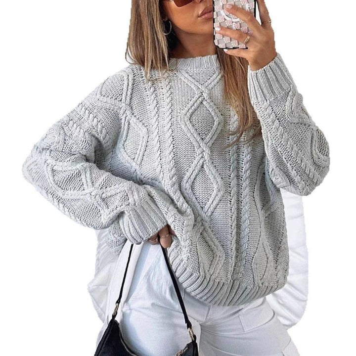 Light gray oversized cable-knit sweater with long sleeves and crew neck