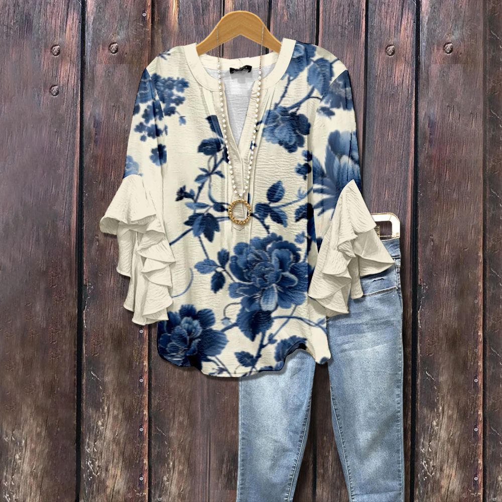 Floral blouse with ruffle sleeves, cream and blue V-neck, button-front detail.
