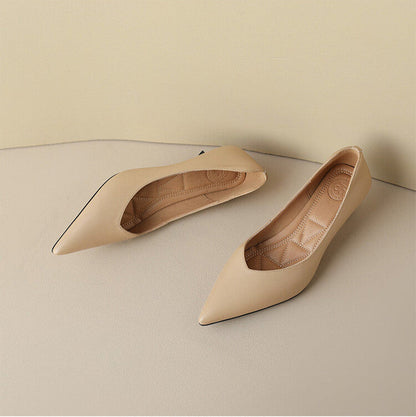 Beige pointed-toe pumps with quilted insole details, pair