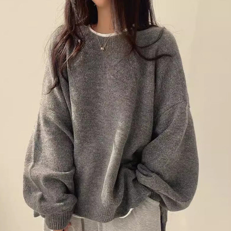 Dark gray oversized knit sweater with crew neck, long sleeves, ribbed cuffs and hem.