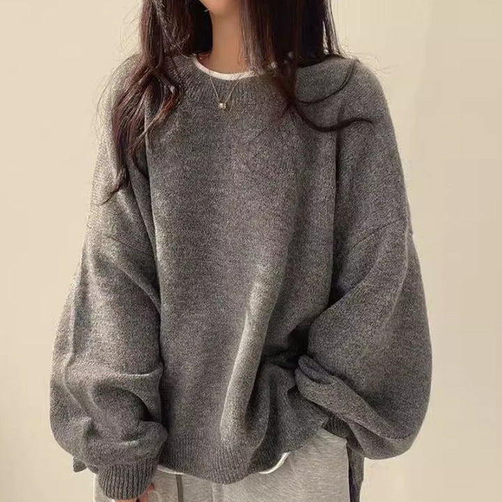Dark gray oversized knit sweater with crew neck, long sleeves, ribbed cuffs and hem.