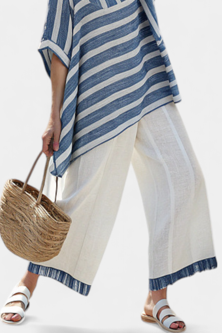 Blue-and-white striped top and white wide-leg trousers with blue hem trim