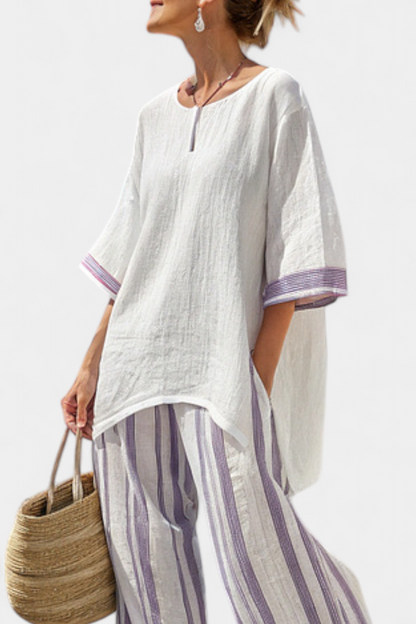 Relaxed white tunic shirt with half sleeves, purple-striped cuffs, paired with striped trousers
