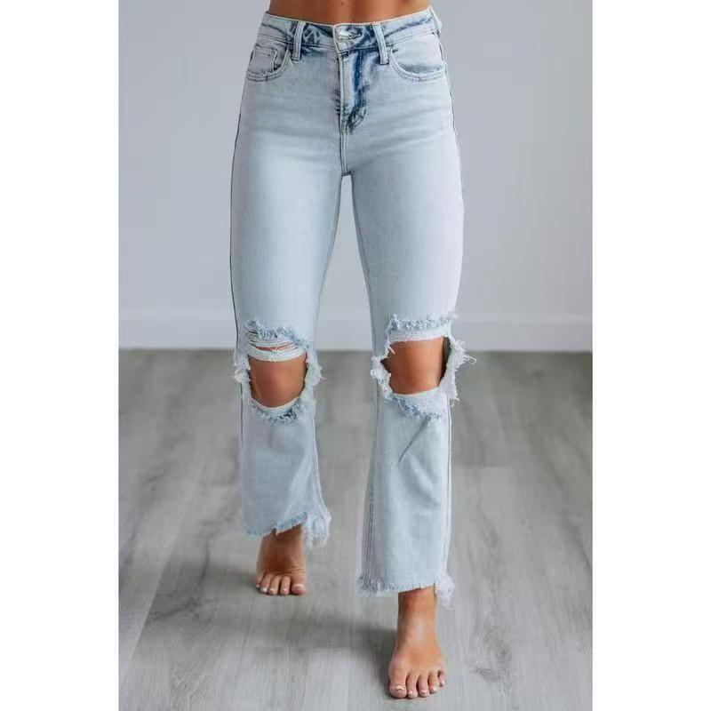 Light blue washed slim-fit ripped jeans with distressed knee and hem openings
