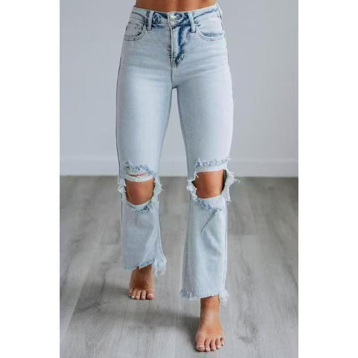 Light blue washed slim-fit ripped jeans with distressed knee and hem openings