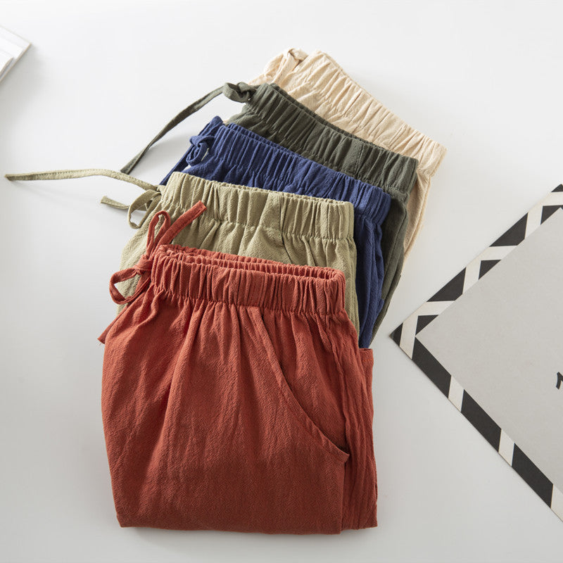 Relaxed-fit shorts stack in cream, olive, navy, and rust red