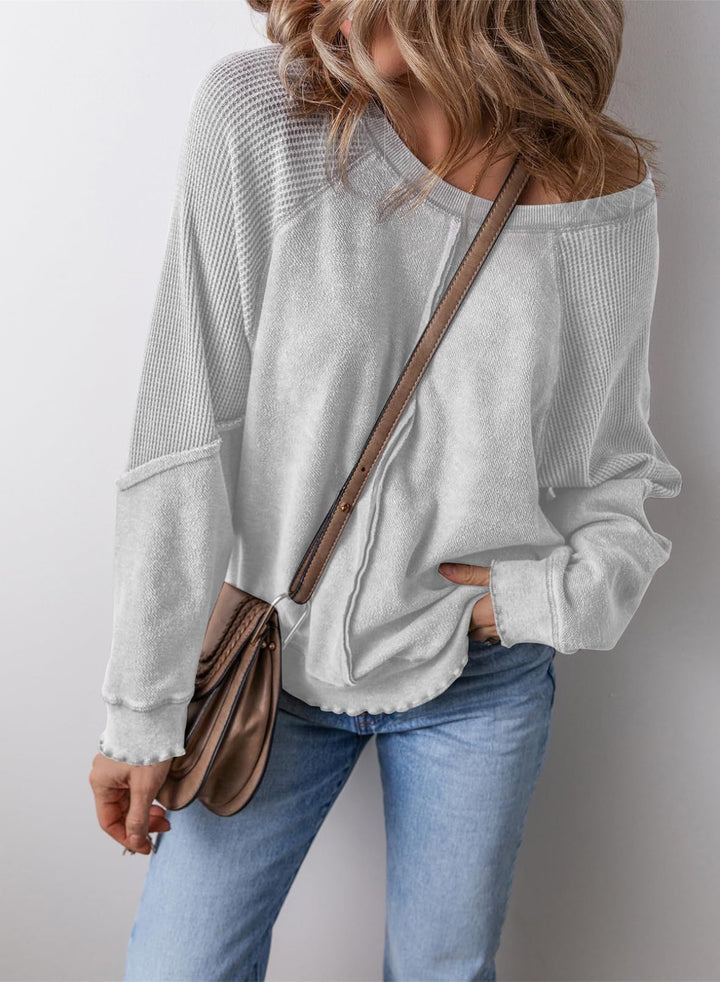 Light gray crew neck long-sleeve sweatshirt with ribbed cuffs and hem
