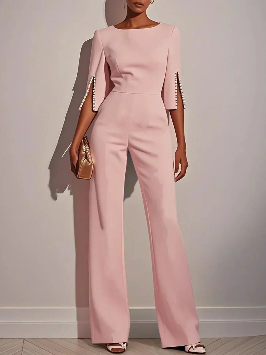 Pink three-piece set with fitted top and wide-leg pants, embellished bell sleeves