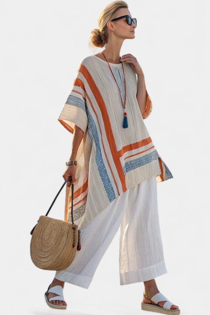 Contrast-striped linen blouse with stepped hem over white wide-leg trousers