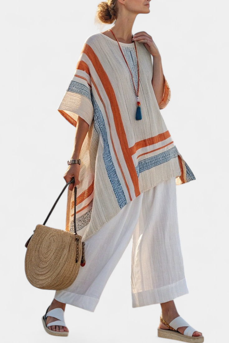 Asymmetric striped linen tunic blouse over white wide-leg trousers