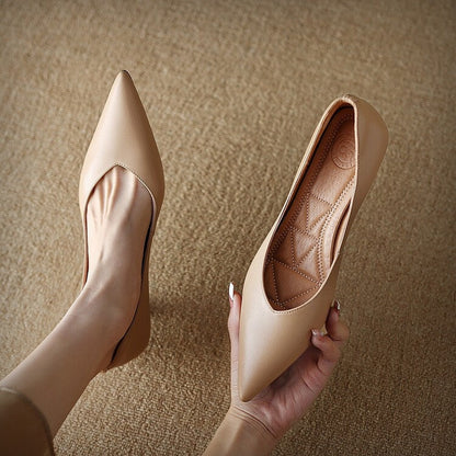 Beige pointed-toe pumps, one shown with quilted insole