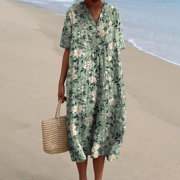 Sage green floral summer dress with V-neck, short sleeves, and gathered waist